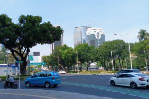 Langit cerah berawan menaungi lanskap gedung perkotaan di Jakarta
